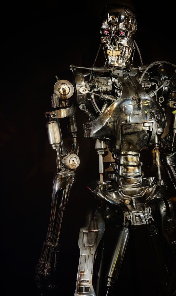 Close-up of a metallic robot showcasing intricate mechanical details in a dark setting.