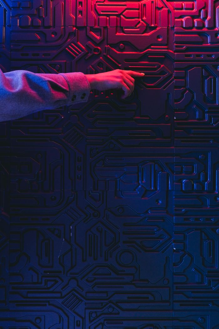 Services A person's hand interacting with a glowing circuit board, creating a modern tech ambiance.